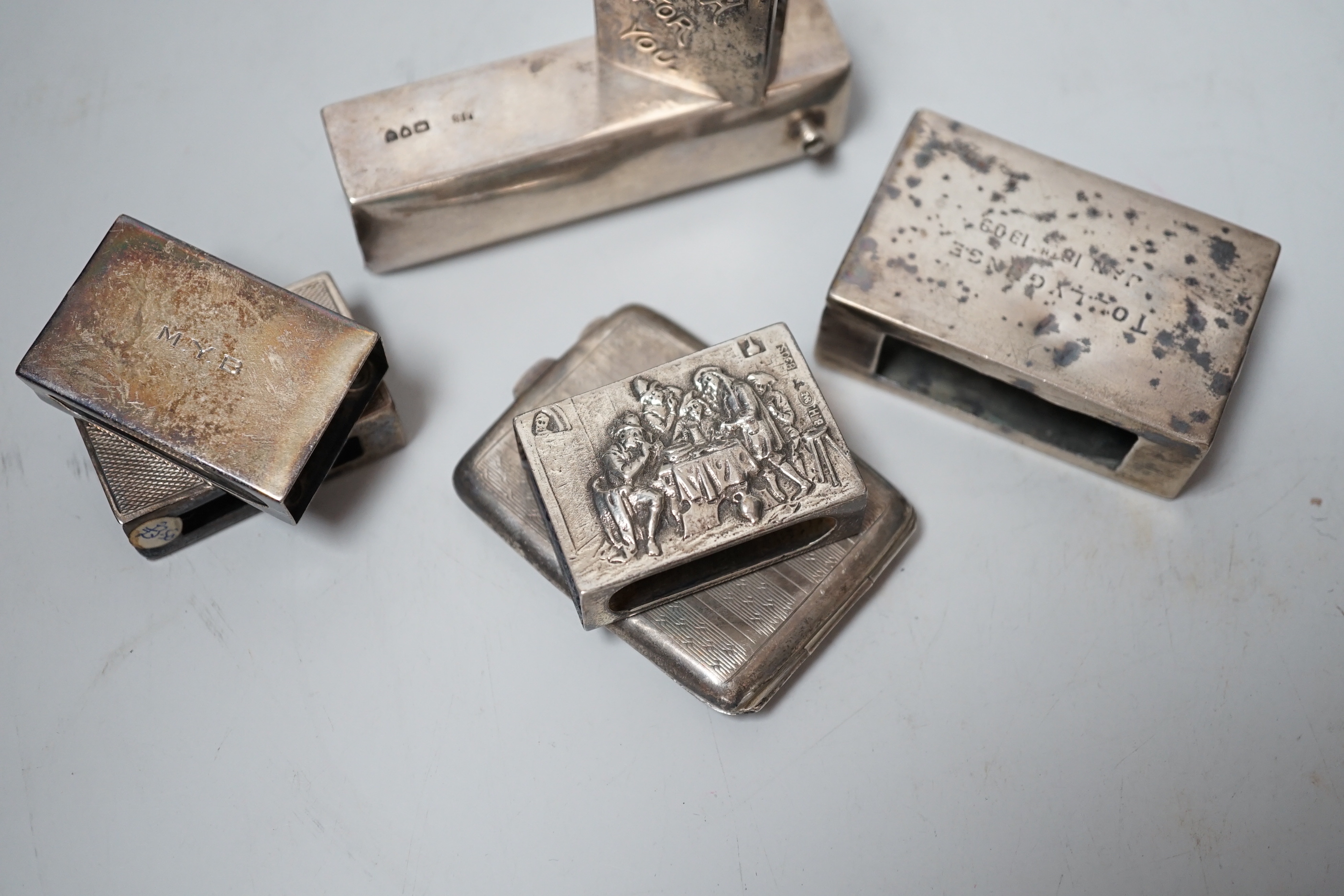 Five assorted mainly early 20th century silver matchbox sleeves and two other items including a matchbook case.